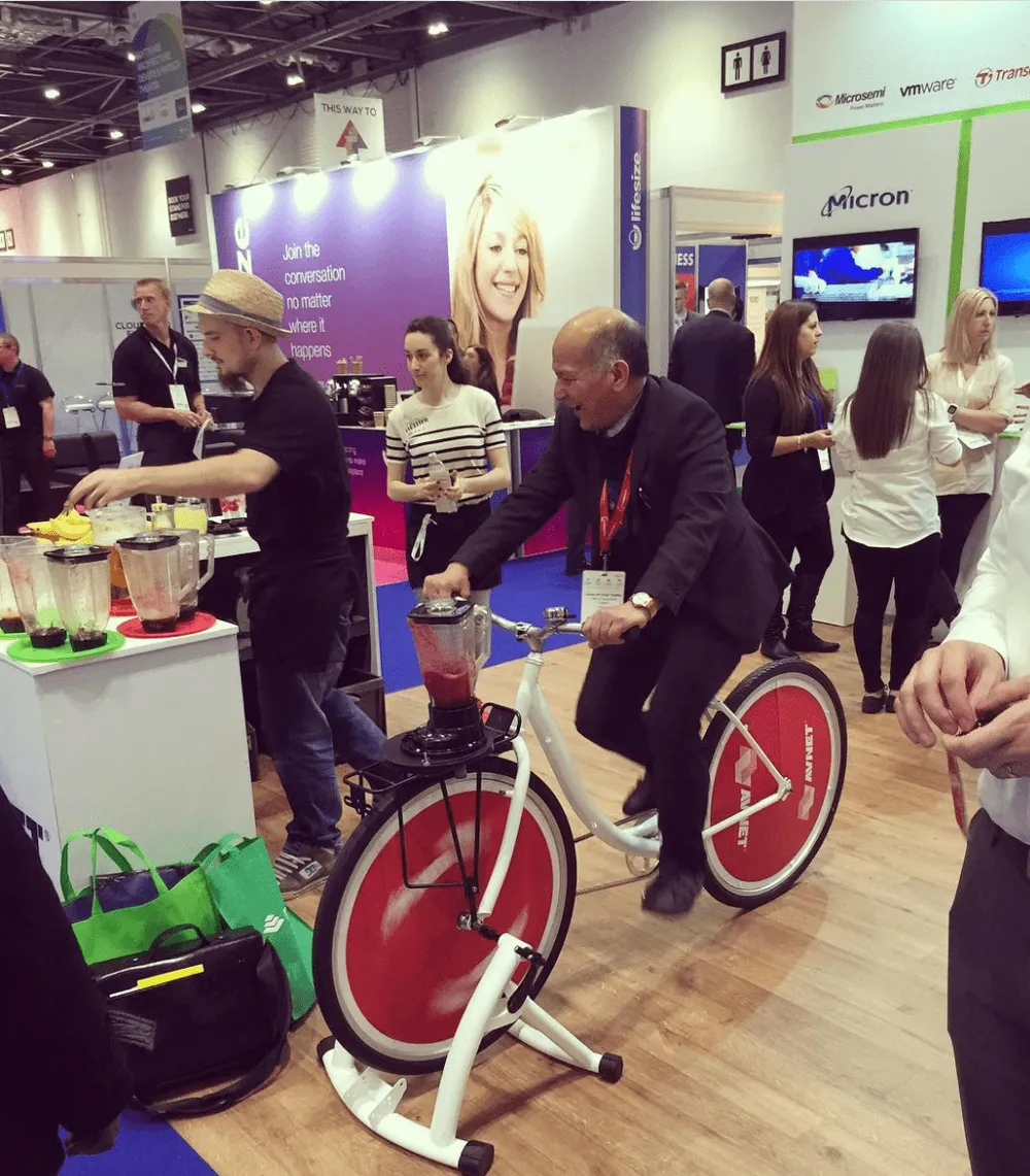 sponsor booth with a stationary e bike that people jump on